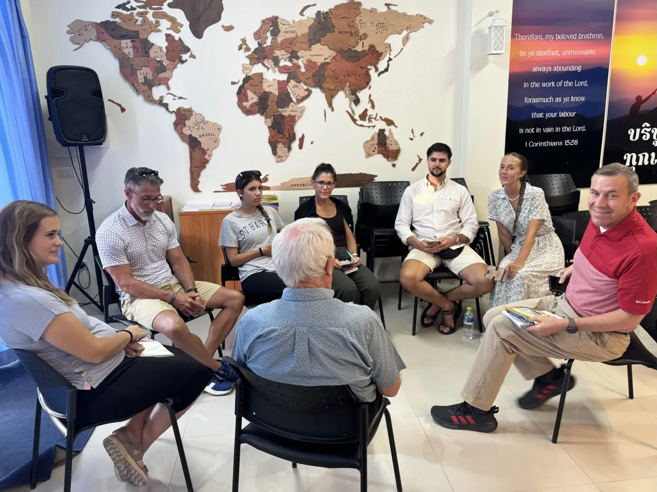 Studying God's Word together beneath a map of the world